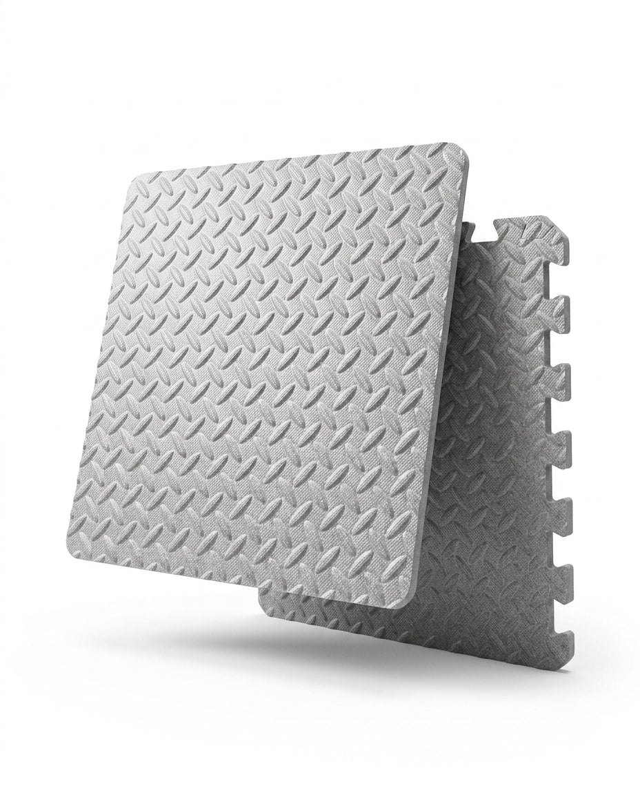 Grey EVA foam puzzle mat tiles with diamond-plate texture on white