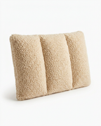 Light tan sherpa lumbar support pillow, angled studio shot on white
