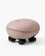 Dusty pink electric scalp massager with black silicone claws on white
