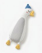 White plush goose baby comfort pillow with blue knit cap, lying flat