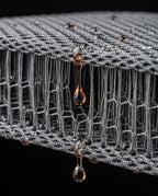 Macro of water draining through the breathable 3D air-mesh of the bath pillow