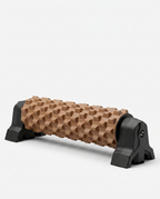 Coffee-brown textured foam roller on a black wall-mount stand, studio shot on white