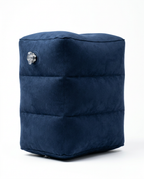 Dark blue inflatable travel footrest pillow, studio shot on white background