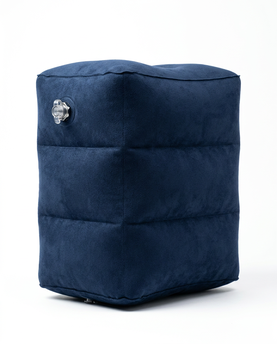 Dark blue inflatable travel footrest pillow, studio shot on white background
