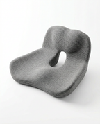 Gray contoured memory foam seat cushion, three-quarter studio view on white