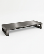 Brushed iron-finish metal monitor riser, angled studio shot on white