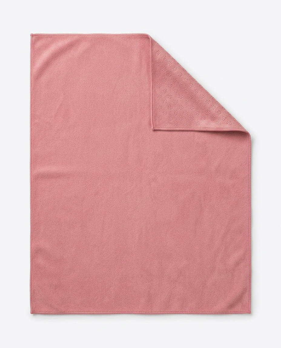 Dusty pink yoga towel flat-laid with one corner folded over