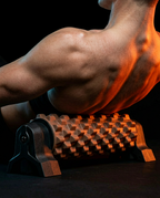 Muscular back pressed onto the foam roller for muscle massage of back muscles