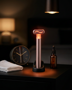 Red light wand glowing in its charging dock on a dim nightstand