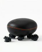 Black electric scalp massager with copper accent line, on white background