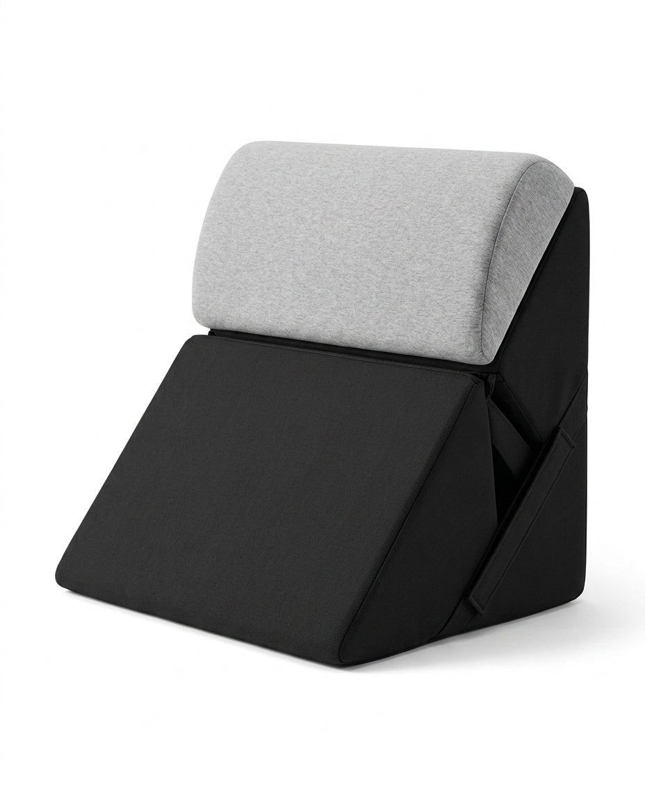 Black wedge lounger with light gray contoured headrest bolster on white