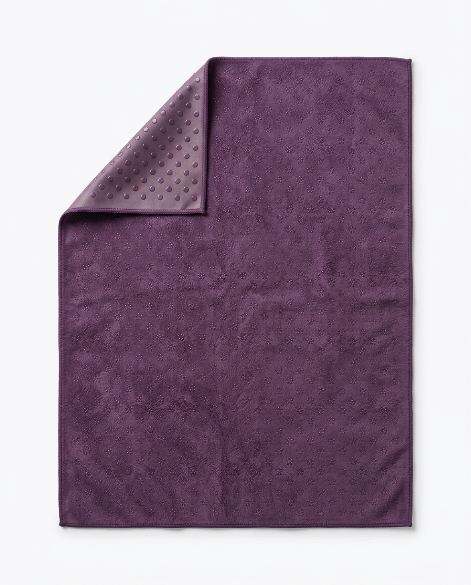 Plum purple yoga towel with corner folded showing grip-dot underside