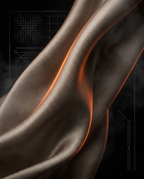 Macro of flowing taupe satin drape lit with a warm orange edge glow