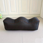 Dark gray leg elevation pillow with twin channels and contrast piping, side view